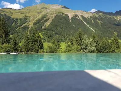 a large body of water with a mountain in the background at Hotel Sonklarhof in Ridanna