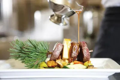 a plate of food with a drizzle of sauce at Hotel Sonklarhof in Ridanna
