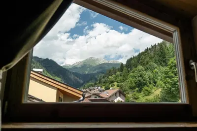 a view from a window of a mountain at Mountain Dolomiti Apartments-Maison Perrod in Predazzo