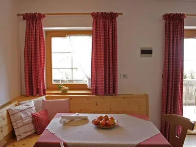a room with a table with a bowl of fruit on it at Residence Streitlhof in Tirolo
