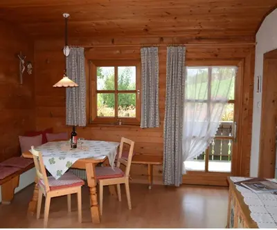 a dining room with a table and chairs in a cabin at Residence Streitlhof in Tirolo