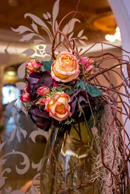 a vase with flowers in it on a table at Albergo Alla Rosa in Canazei