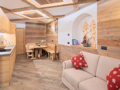 a kitchen and living room with a couch and a table at CESA MARIN in Campitello di Fassa