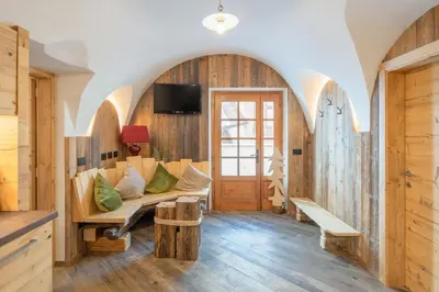 a living room with a couch and a tv at CESA MARIN in Campitello di Fassa