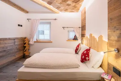 a bedroom with two beds in a room at CESA MARIN in Campitello di Fassa
