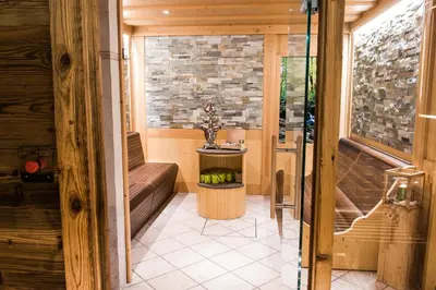 a small room with a bench and a table at Garni Hotel Iris in Selva di Val Gardena