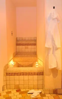 a bathroom with two bunk beds in a room at Garni Hotel Iris in Selva di Val Gardena
