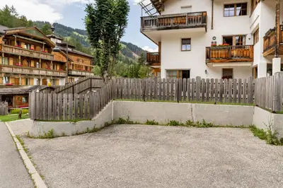 a wooden fence in front of a building at Aurturist Appartement 185 in San Vigilio Di Marebbe