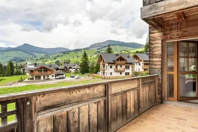 a view from the balcony of a home with a wooden fence at Aurturist Appartement 185 in San Vigilio Di Marebbe