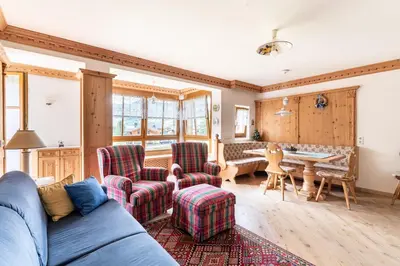 a living room with a couch and chairs and a table at Aurturist Appartement 185 in San Vigilio Di Marebbe