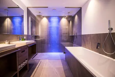 a bathroom with two sinks and a tub and a shower at Hotel Kronblick in Chienes