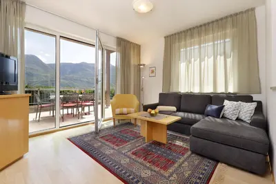 a living room with a couch and a table at Hotel Törggelehof in Cermes