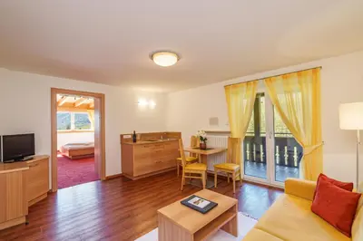 a living room with a couch and a table at Hotel Törggelehof in Cermes