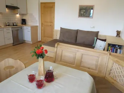 a living room with a table with a vase of flowers at Rasiglerhof in Villandro