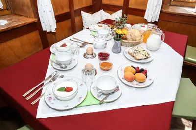 a table with plates of food on top of it at Rasiglerhof in Villandro