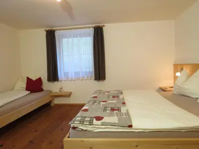a small bedroom with a bed and a window at Rasiglerhof in Villandro