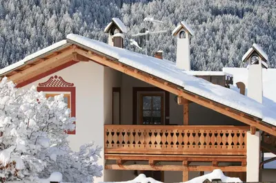 a house with a roof covered in snow at Agriturismo Maso Larciunei in Selva di Val Gardena