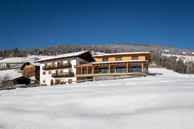 a house in the snow with a lot of snow at Schweiggerhof -Agriturismo- Farm Holidays in Villandro