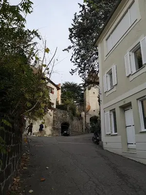 two people walking down a street next to a building at Space Nr. 11 in Merano