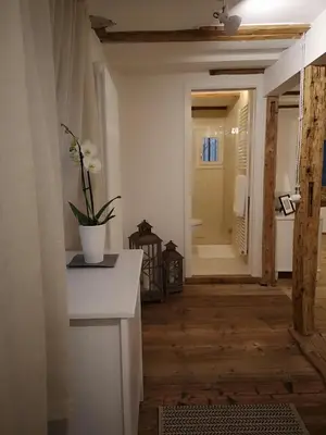 a bathroom with a vase of flowers on a counter at Space Nr. 11 in Merano