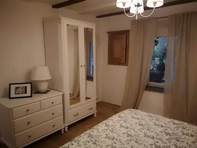 a bedroom with a bed and a dresser and a mirror at Space Nr. 11 in Merano