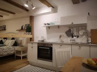 a kitchen with white cabinets and a stove top oven at Space Nr. 11 in Merano