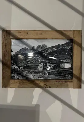 a picture hanging on a wall in a wooden frame at Garnì Letizia in Campitello di Fassa