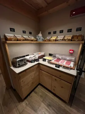 a bakery counter with lots of different types of bread at Garnì Letizia in Campitello di Fassa