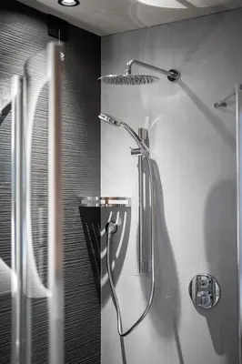 a shower stall in a bathroom with a shower head at Garnì Letizia in Campitello di Fassa