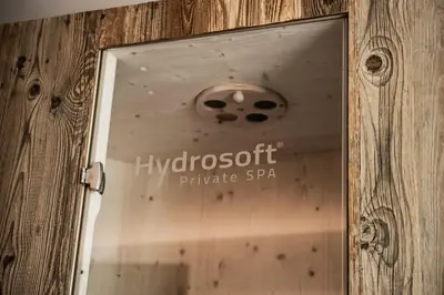 a door with a sign that readshydrogenopt private spa at Cadepunt The Dolomites Lodge in Selva di Val Gardena