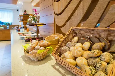 a bakery with baskets of bread and other foods at Hotel Zum Tiroler Adler in Tirolo