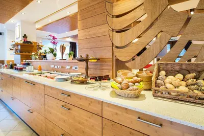 a kitchen with lots of food on a counter at Hotel Zum Tiroler Adler in Tirolo