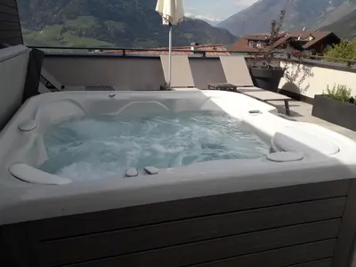 a jacuzzi tub with a view of a mountain at Hotel Zum Tiroler Adler in Tirolo