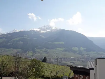a mountain in the distance with a town and a mountain at Hotel Zum Tiroler Adler in Tirolo