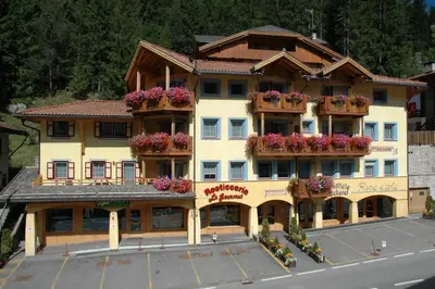 a large building with flower boxes on the balconies at Casa Maurivan in Canazei