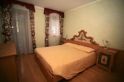 a living room with a table and chairs and a couch at Casa Maurivan in Canazei