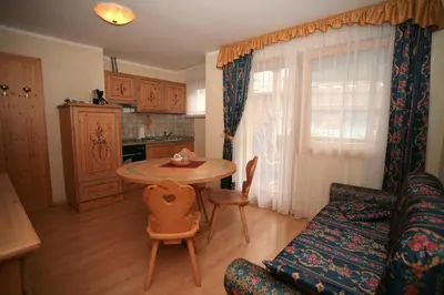 a bedroom with a bed and a lamp in it at Casa Maurivan in Canazei