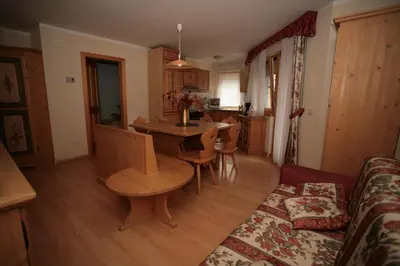 a living room with a table and a couch at Casa Maurivan in Canazei