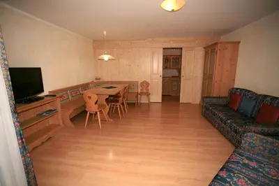 a kitchen with a wooden table and a microwave at Casa Maurivan in Canazei