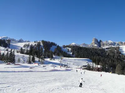 a group of people skiing down a snow covered slope at Garni Irsara in San Cassiano