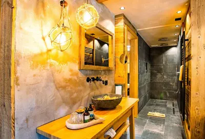 a bathroom with a counter with a sink in it at Mons Silva Private Luxury Chalets in Racines