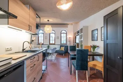 a kitchen and dining room with a table and chairs at Schloss-Castel Pienzenau - Guestrooms & Apartments - B&B-Hotel & Restaurant in Merano