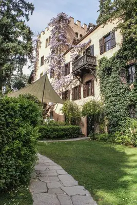 a building with a tent in front of it at Schloss-Castel Pienzenau - Guestrooms & Apartments - B&B-Hotel & Restaurant in Merano