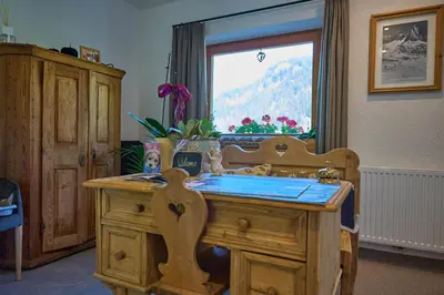 a wooden desk with a sink and a window at Hotel Monte44 in Selva di Val Gardena