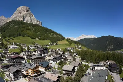 an aerial view of a village in the mountains at Hotel Tabladel in Colfosco
