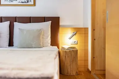 a bedroom with a bed and a table with a lamp at Ritschhof in Laion