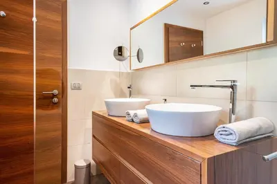 a bathroom with two sinks on a wooden counter at Ritschhof in Laion