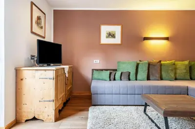 a living room with a couch and a tv at Ritschhof in Laion