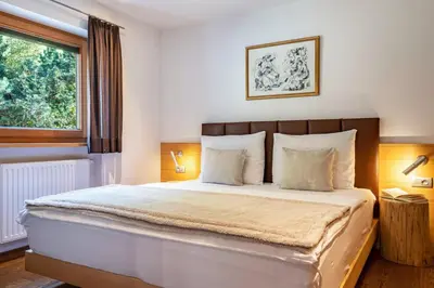 a bedroom with a large bed with a window at Ritschhof in Laion