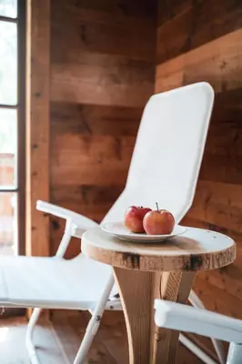 two apples on a table next to a chair at Hotel Chalet Corso in San Vigilio Di Marebbe